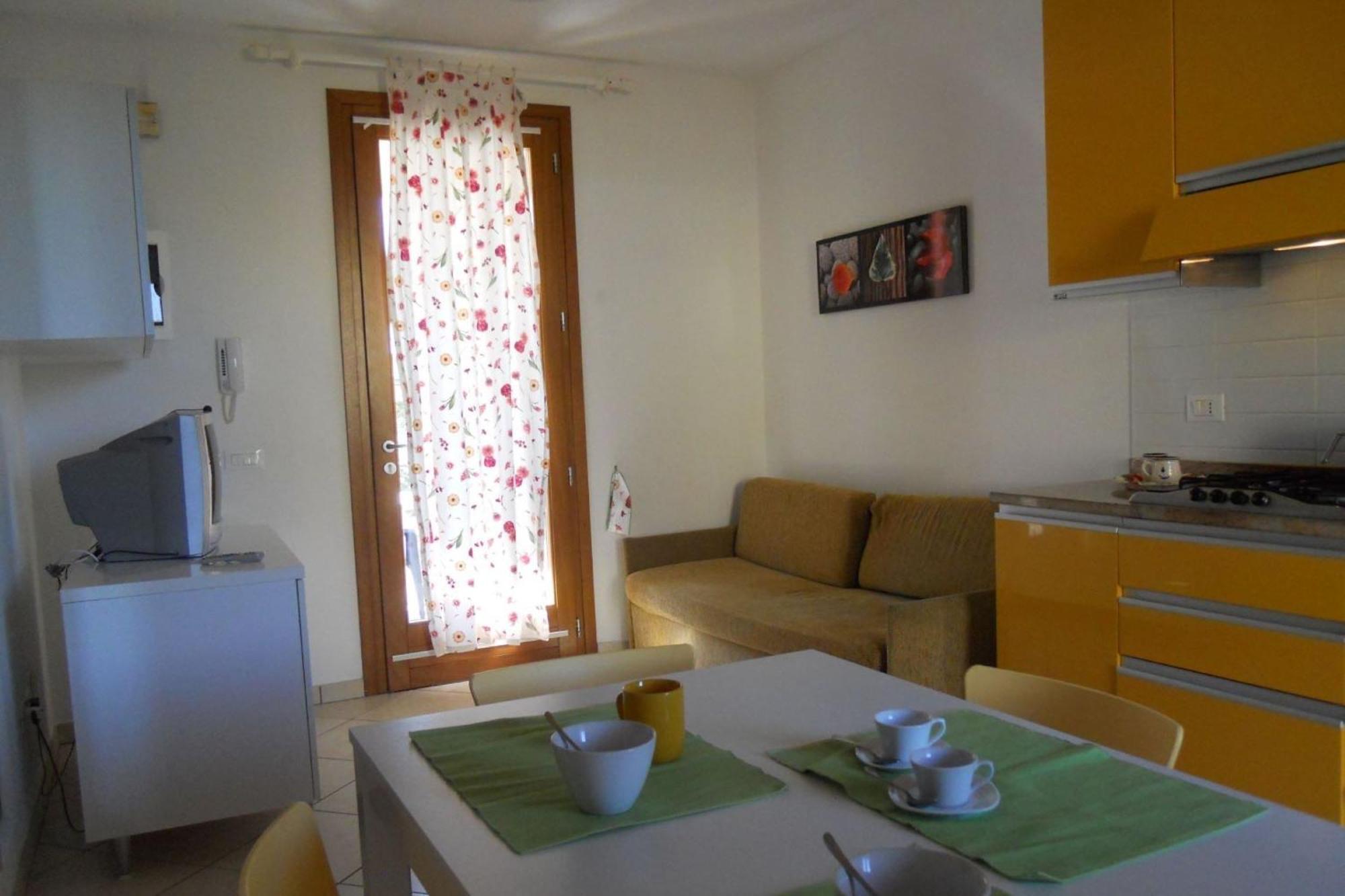 Colorful With Fenced Garden And Fireplace Bibione